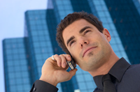 Businessman on cell phone outside office building